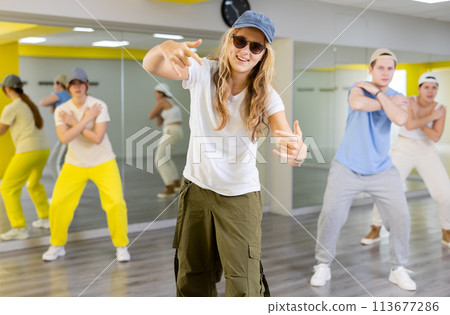 Boys and girls performing contemporary dance in studio. 113677286