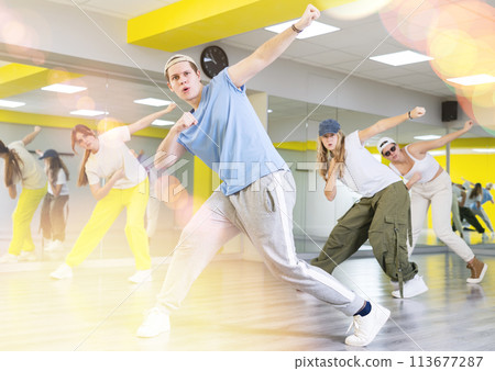Portrait of teenager boy performing hip hop at dance class Portrait of teenager boy performing hip hop at dance class 113677287