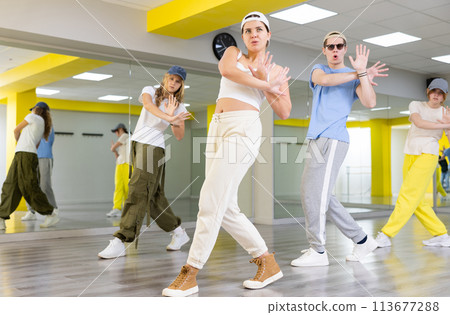 Young girl in cap dancing hip hop Young girl in cap dancing hip hop 113677288
