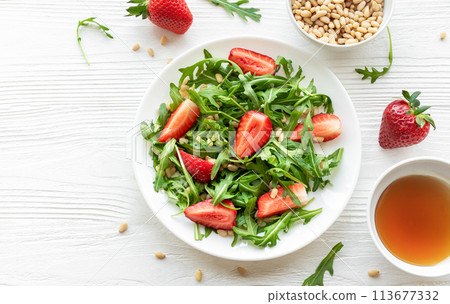 Fresh Strawberry Arugula Salad With Pine Nuts Served on a Bright Day Fresh Strawberry Arugula Salad With Pine Nuts Served on a Bright Day 113677332