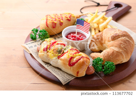 Junk food (sausage rolls, croissants, corn dogs and french fries) Junk food (sausage rolls, croissants, corn dogs and french fries) 113677702