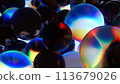An array of dark spheres with a colorful glare.. 113679026
