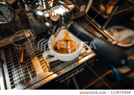 Expresso Coffee machine making a coffee,Fresh espresso shot pouring out of machine Expresso Coffee machine making a coffee,Fresh espresso shot pouring out of machine 113679494