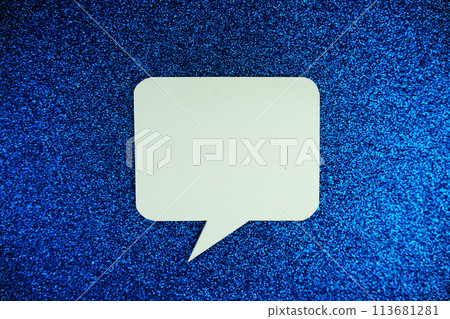 White Speech bubble mockup top view on blue glitter background 113681281