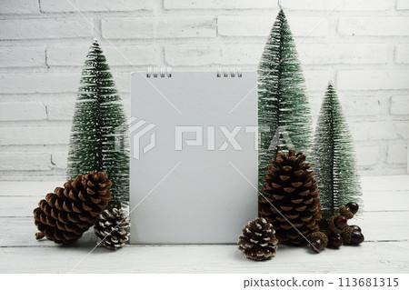 Empty calendar mockup with christmas tree and house lantern decoration on wooden background Empty calendar mockup with christmas tree and house lantern decoration on wooden background 113681315
