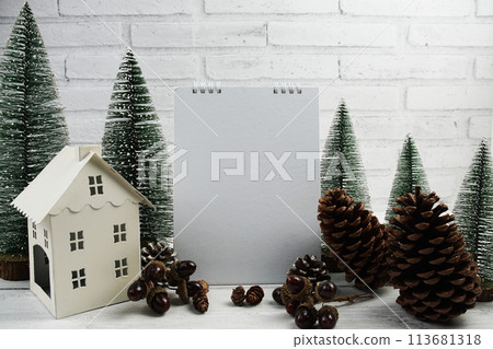 Empty calendar mockup with christmas tree and house lantern decoration on wooden background Empty calendar mockup with christmas tree and house lantern decoration on wooden background 113681318