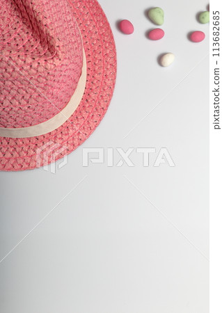 Summer holiday accessories. Sun hat. Nearby are colored pebbles on a white background. Summer holiday accessories. Sun hat. Nearby are colored pebbles on a white background. 113682685