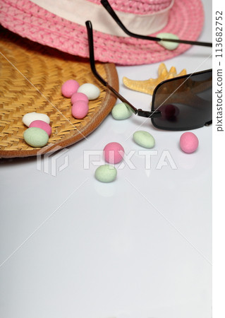 Accessories for summer holidays. Sun hats, sunglasses, colored pebbles and starfish on a white background. Accessories for summer holidays. Sun hats, sunglasses, colored pebbles and starfish on a white background. 113682752