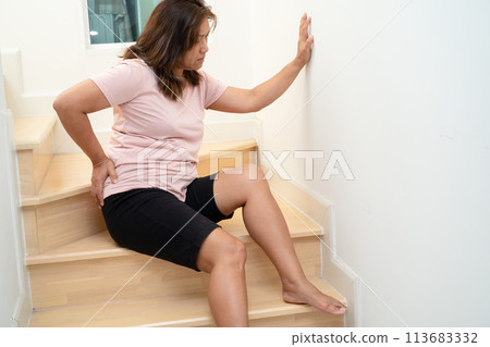Asian lady fall down the stairs and pain at hip and waist because slippery surfaces. 113683332
