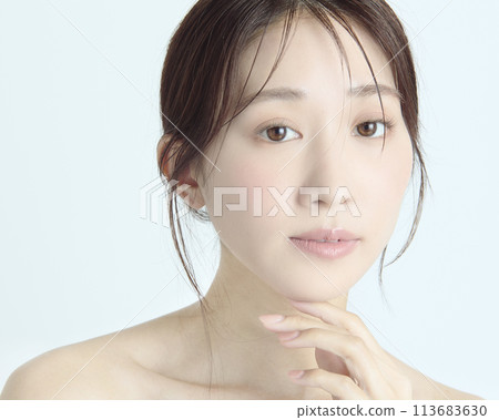 Close-up upper body portrait of a young woman on a white background Close-up upper body portrait of a young woman on a white background 113683630
