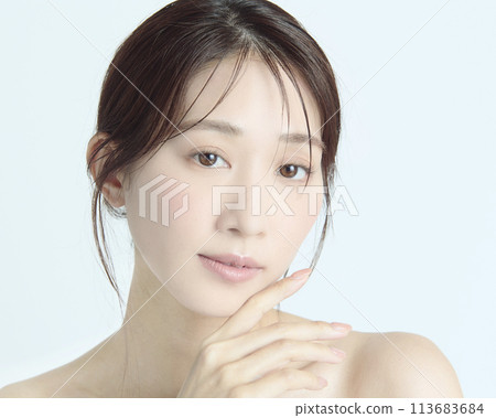Close-up upper body portrait of a young woman on a white background 113683684