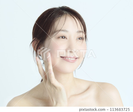 Close-up upper body portrait of a young woman on a white background Close-up upper body portrait of a young woman on a white background 113683725