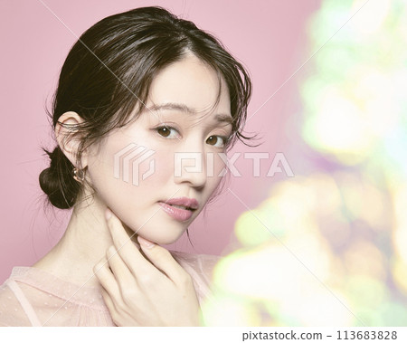 Portrait of a young glamorous woman against a pink background Portrait of a young glamorous woman against a pink background 113683828