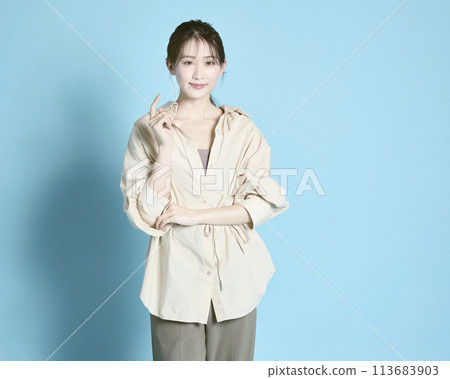 Portrait of a young woman against a blue background 113683903