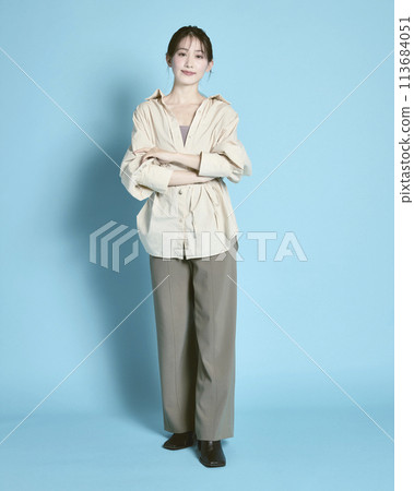 Portrait of a young woman against a blue background 113684051