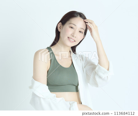 Portrait of a healthy young woman on white background 113684112
