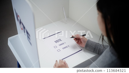 Asian female voter votes for Republican Party in paper ballot 113684321