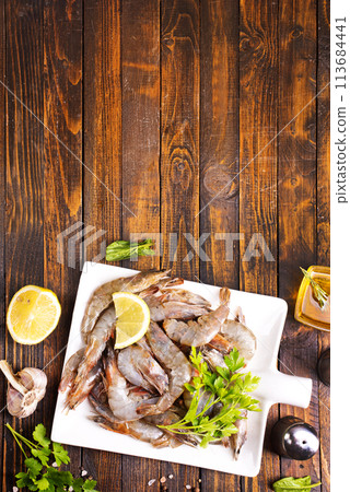 Uncooked Raw peeled tiger white shrimp prawn. wooden background. 113684441