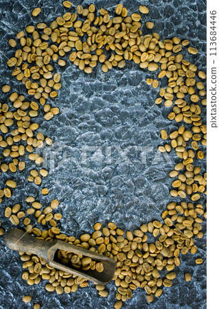 Green coffee beans on black table 113684446