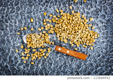 Green coffee beans on black table 113684452