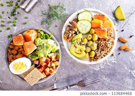 salad with salmon, boiled egg, bean, tomato, salad and almond nuts. salad with salmon, boiled egg, bean, tomato, salad and almond nuts. 113684468