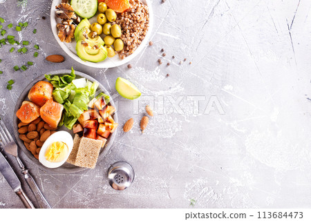 salad with salmon, boiled egg, bean, tomato, salad and almond nuts. salad with salmon, boiled egg, bean, tomato, salad and almond nuts. 113684473