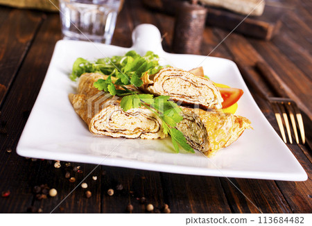 Dashimaki tamago, Japanese style rolled omelette in dish on wooden table 113684482
