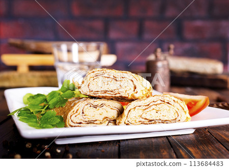 Dashimaki tamago, Japanese style rolled omelette in dish on wooden table Dashimaki tamago, Japanese style rolled omelette in dish on wooden table 113684483