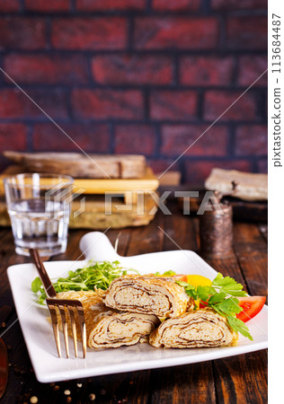 Dashimaki tamago, Japanese style rolled omelette in dish on wooden table 113684487