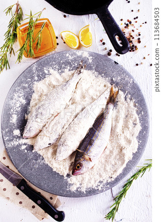Fillet fish coated in flour. Home cooked fish fillet. Fillet fish coated in flour. Home cooked fish fillet. 113684503