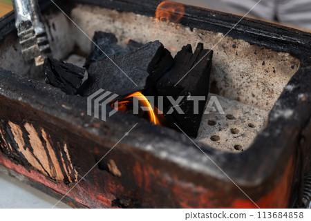Burning charcoal 113684858