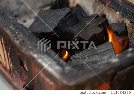Burning charcoal 113684859