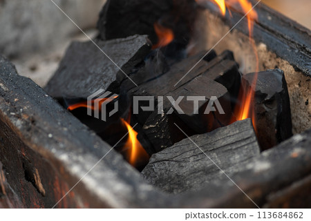 Burning charcoal 113684862