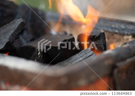 Burning charcoal Burning charcoal 113684863
