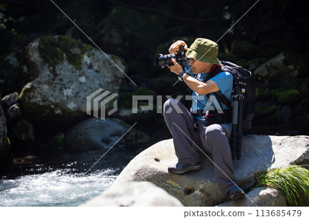 Photographer taking pictures of the landscape 113685479