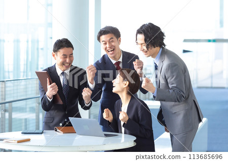Business people celebrating with fist pumps 113685696