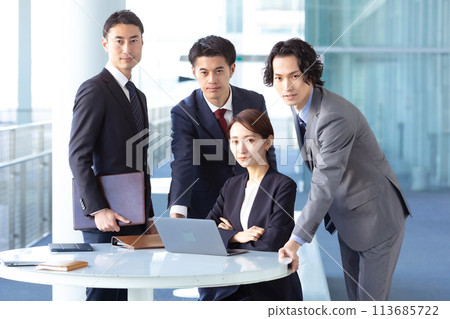 Business men and women looking at camera Business men and women looking at camera 113685722