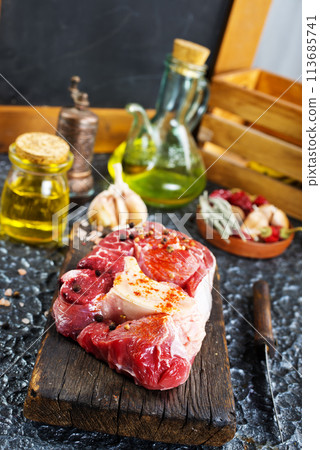 raw meat on board, meat with spice 113685741