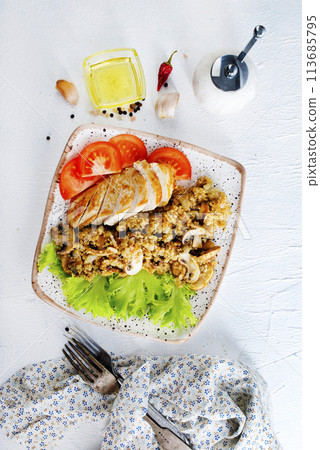 baked chicken breast with mushroom quinoa and salad 113685795