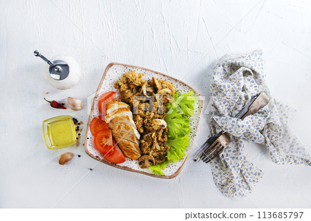 baked chicken breast with mushroom quinoa and salad 113685797