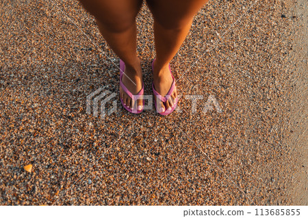 Feet on the sand at the beach at dusk Feet on the sand at the beach at dusk 113685855