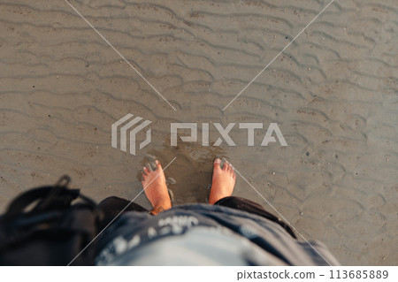 Feet on the sand at the beach at dusk Feet on the sand at the beach at dusk 113685889