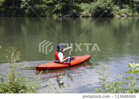 Young man enjoying kayaking Young man enjoying kayaking 113686068