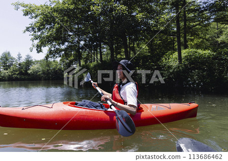 man enjoying kayaking man enjoying kayaking 113686462