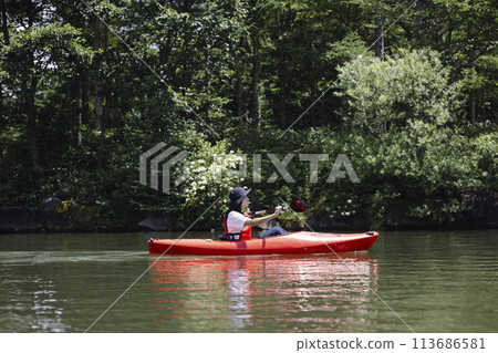 man enjoying kayaking man enjoying kayaking 113686581