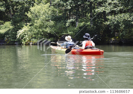 Parent and child enjoying kayaking Parent and child enjoying kayaking 113686657