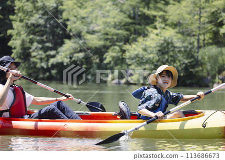 Parent and child enjoying kayaking Parent and child enjoying kayaking 113686673