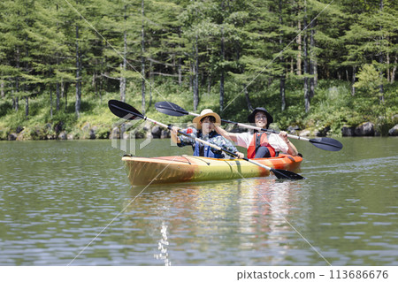 Parent and child enjoying kayaking Parent and child enjoying kayaking 113686676