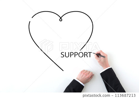Hands of a businessman drawing a heart and the word support 113687213