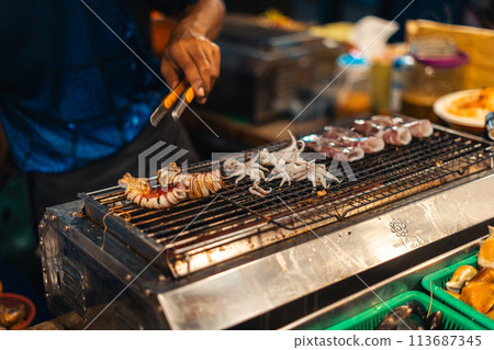 Squid grilled on the grill at Street Food Market Squid grilled on the grill at Street Food Market 113687345